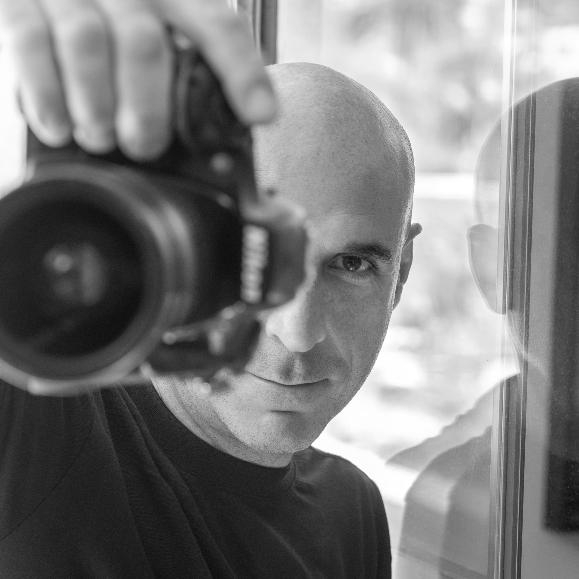 Matt Vacca, black-and-white portrait with camera